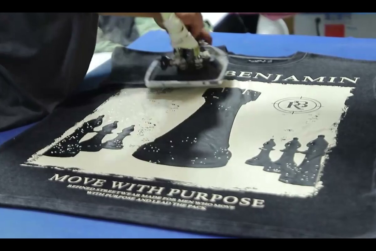 Factory heat pressing a print on a T-shirt