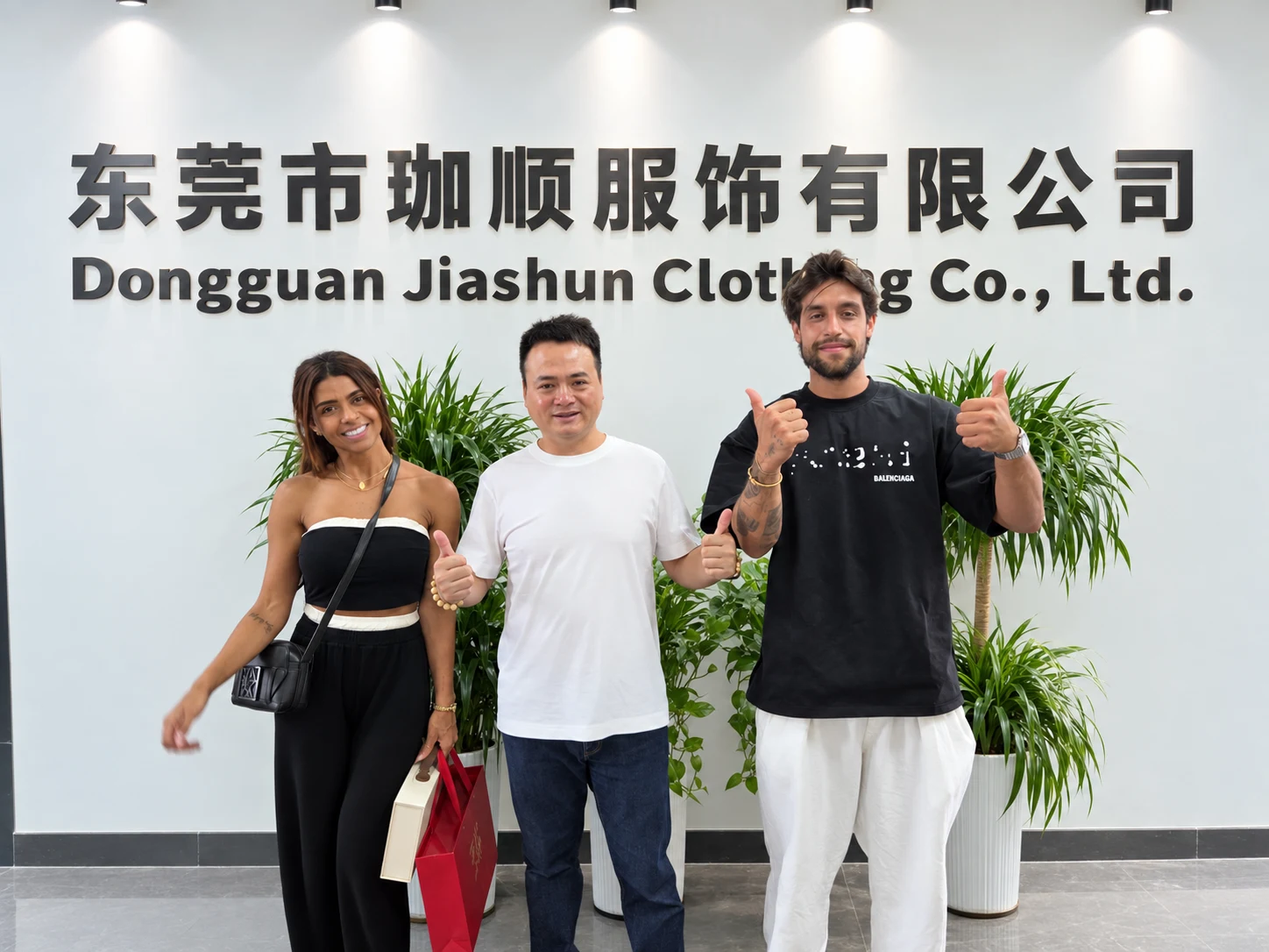Customers visiting Jiashun in front of the company sign
