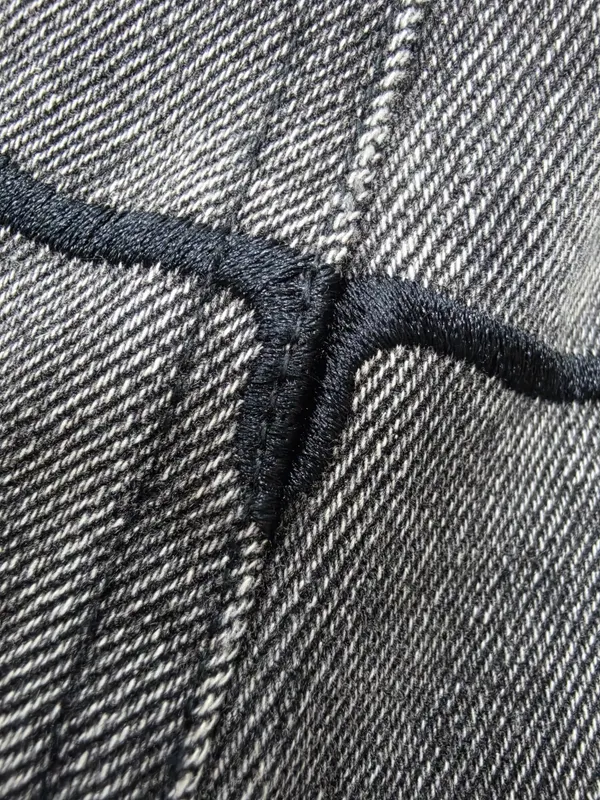 Actual black decorative stitching on grey denim