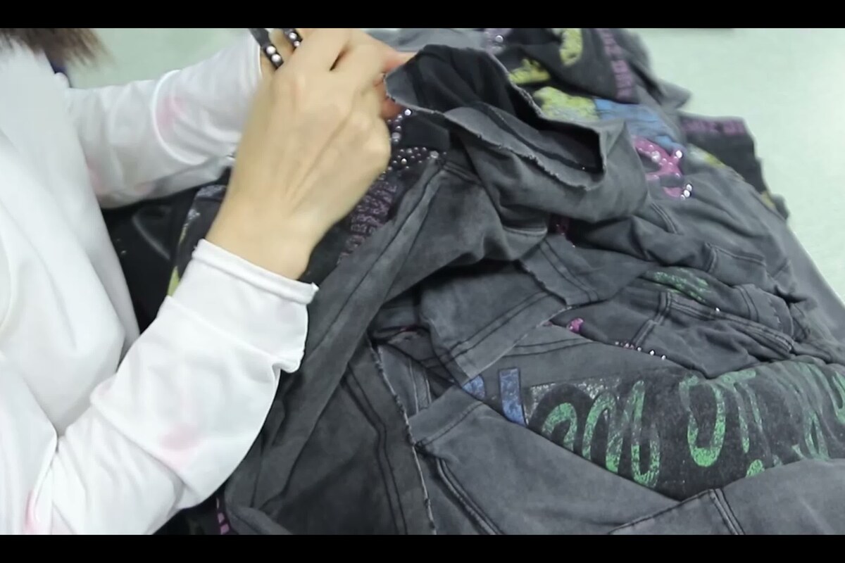 Worker checking finished garment detail